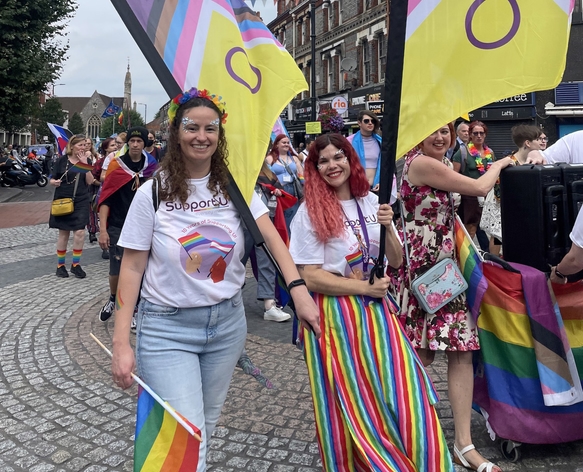 picture for projectStory: Two people holding flags at a Pride march