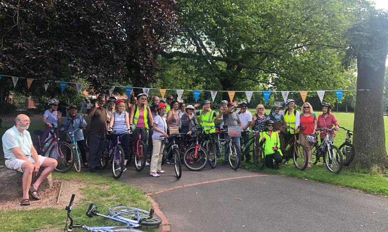 A group of participants posing with bikes