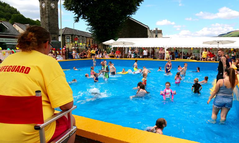 Volunteer lifeguard watches over people enjoying Lee Gardens Pool