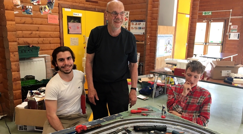 picture for projectStory: Three project participants sit around a train set at The Engine Shed